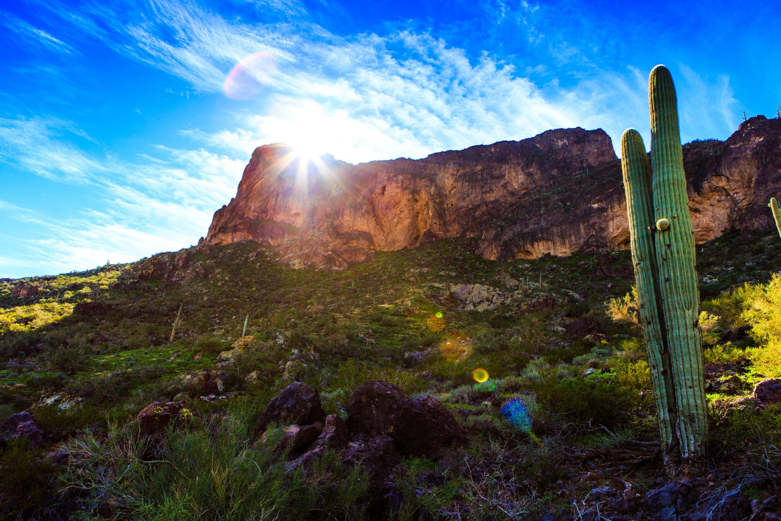 Desert view with sun just above rocks